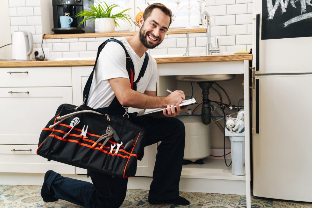 Plumber writing a job estimate on a clipboard