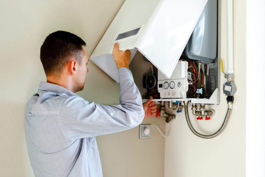 Plumber repairing a residential water heater